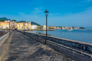 Seaside view of Porto d'Ischia town viewed from a bridge to the Aragonese castle at Ischia island, Italy