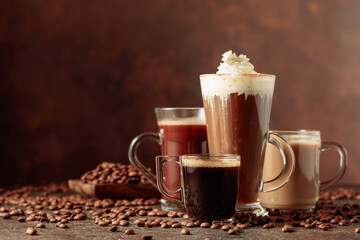 Various coffee and chocolate drinks on a brown background.