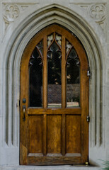 Fototapeta na wymiar Wooden Door in Stone Archway
