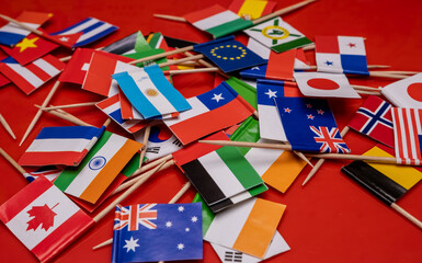 Small flags of different countries of the world on the table.