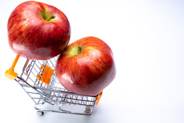 Apples in a cart on a white background close-up.