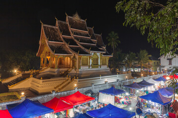 Fototapeta na wymiar Aerial view of the Haw Pha Bang Temple or Royal Palace in Luang Prabang and night market, Laos