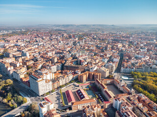 Aerial perspective of Valladolid city center at sunrise. View of Plaza Mayor and Cathedral of Valladolid. Sun in the right corner of the camera. Beautiful panoramic view of the city. 