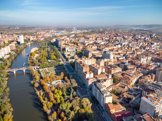 Aerial point of view of Valladolid city. View of River Pisuerga and Juan de Austria Bridge. At the right is the city center of Valladolid. Travel destination in Spain.   - obrazy, fototapety, plakaty