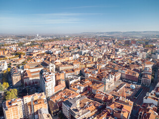 Aerial perspective of Valladolid city center at sunrise. View of Plaza Mayor and Cathedral of Valladolid. Sun in the right corner of the camera. Beautiful panoramic view of the city.  - obrazy, fototapety, plakaty