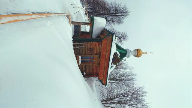 View of the chapel near the Belogorsky St. Nicholas Orthodox Missionary Monastery. Winter forest. The temple on the hill in winter. Russia, Perm Krai, Belaya Gora. 4K