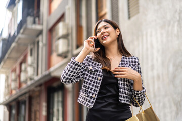 Portrait of smiling happy beauty asian business woman relaxing using digital technology smartphone.Young asian girl work call and talk with friend business team at city