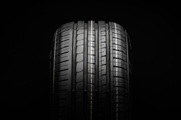 Summer tire. Profile of a summer tire on a black background close-up
