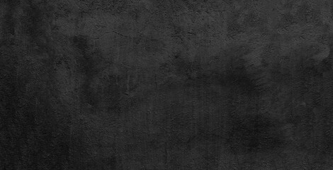 Wide black concrete wall texture background. Dark gray rock surface panoramic backdrop