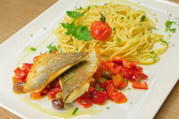 fish grilled pike-perch fillet paprika-olive ragout with spaghetti with chili, garlic and anchovies seafood