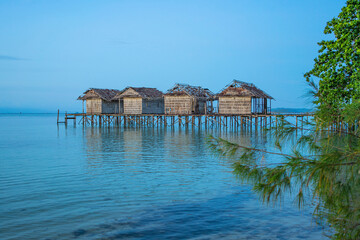 Destroyed water houses at the coastline of Saporkren on Waisai island, Raja Ampat