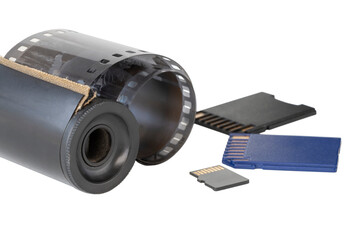 Micro SD card against vintage roll film in reel, on isolated background