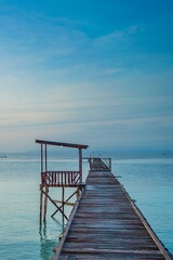 Obraz premium Pier in morning time at the coastline of the village of Saporkren Waisai, Raja Ampat
