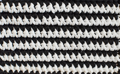 Black and white horizontal stripes - crocheted texture background, concept of contrast in life, ups...