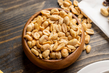 Fried crispy peanuts in a wooden bowl
