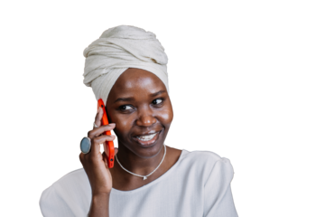 Nice African girl in turban talks by phone against transparent background smiles wide happy  hear parents, missing them after relocation. Successful African American businesswoman talking with partner