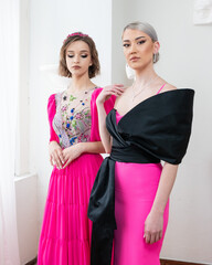 A model wears and black pink dress with