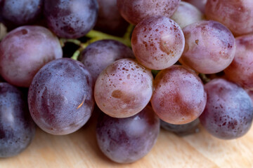 Ripe blue grapes on the kitchen table