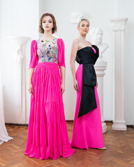 A model wears and black pink dress with