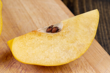 Sliced ripe yellow quince on a cutting board