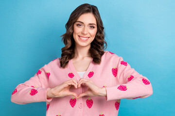 Portrait photo of adorable young woman wear pink strawberry print cardigan show sympathy symbol love story isolated on blue color background