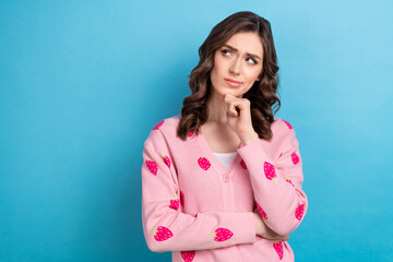 Photo portrait of pretty dreamy funny girl touch chin thoughtful looking empty space unsure bad product high price isolated on blue color background