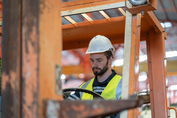 Male worker driving a forklift