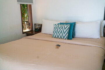 Pillow on white bed in cozy resort resident room
