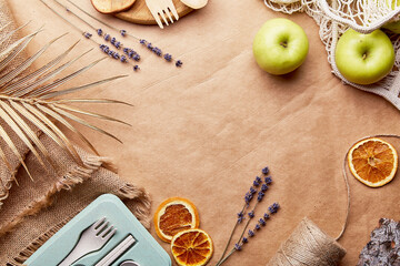Aesthetic, natural, eco-friendly concept. Eco shopping bag with wooden and paper cutlery, apples,...