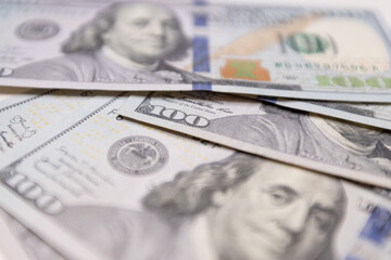  A close-up of a hundred dollar bill featuring Benjamin Franklin, the iconic symbol of American...