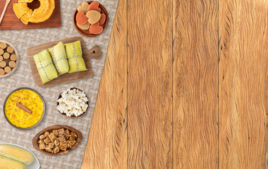 Typical brazilian june festival food over wooden table with copy space. Festa junina