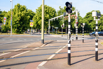 Traffic signals at an intersection between streets, tramways and bicycle lanes in a city centre on a sunny summer day