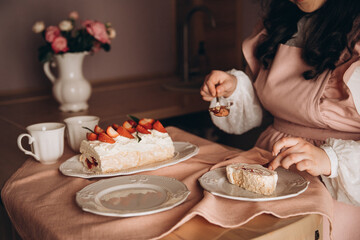 meringue cake combined with fresh strawberries on a background of a pink tablecloth