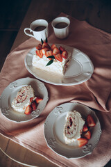 meringue cake combined with fresh strawberries on a background of a pink tablecloth
