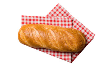 Freshly baked delicious french bread with napkin isolated on white background top view. Healthy white bread loaf