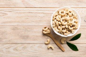 cashew nuts in wooden bowl on table background. top view. Space for text Healthy food