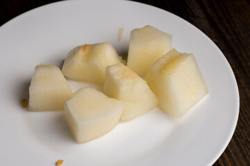 Ripe yellow melon cut into pieces and portions