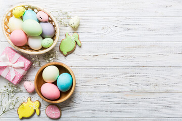 Easter frame with eggs, gift box and tulip on a colored background. The minimal concept. Top view Happy Easter composition. Card with a copy space of the place for the text