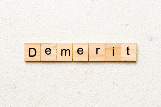 demerit word written on wood block. demerit text on table, concept