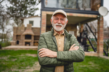 One senior man stand outdoor in front of his house happy confident