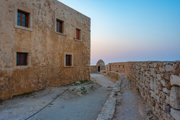 Sunset view of buildings at Venetian Fortezza Castle in Greek town Rethimno, Crete