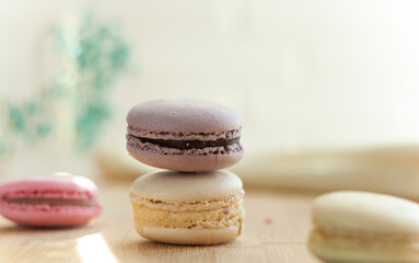 Selective focus. Macaroons stand in a column. Close up shot of food. French dessert. Multifaceted photo. Photo taken with an old Helios 44 lens.