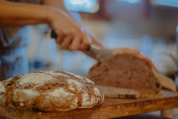 cutting slice of homemade bread