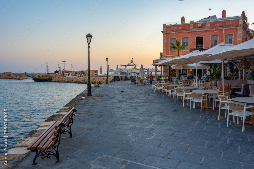 Wall mural Sunrise view of the old Venetian harbor at Greek town Chania, Greece