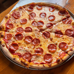 A classic New York-style pizza has a thin, foldable crust, tangy tomato sauce, melted mozzarella cheese, and pepperoni. It's a staple food in the city and can be found at nearly every pizzeria.