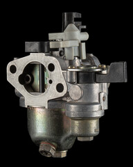 Carburetor, part of a gasoline internal combustion engine, spare part, isolated on a black...