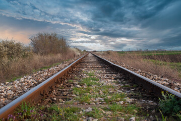 Fototapeta premium Old non electrified railway track at sunrise and dawn sky