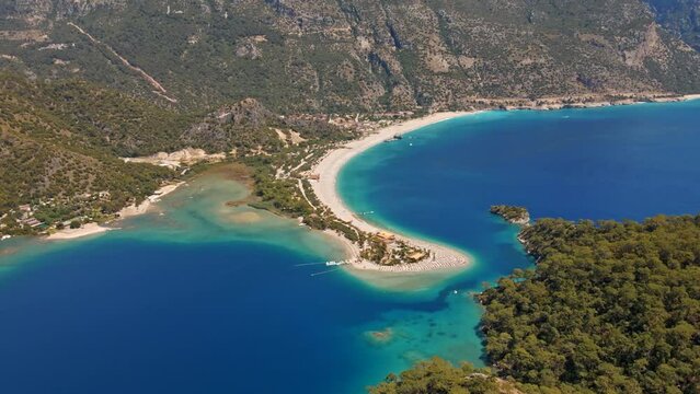 Oludeniz is a resort village on the southwest coast of Turkey. known for the blue lagoon of Oludeniz Tabiat Parki and the wide, white Belcekiz Beach.