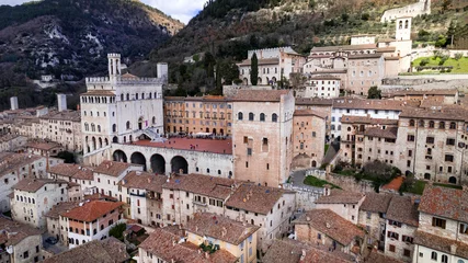 Poster great historical italian landmarks and best tourist destinations - impressive Gubbio in Umbria. Aerial drone panoramic view of medieval town. Italy travel © Freesurf