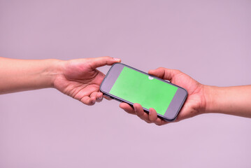 Male hand holding cell phone on white background with green screen